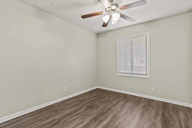 empty room with ceiling fan and dark hardwood / wood-style flooring