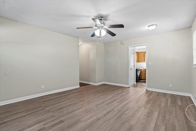 empty room with ceiling fan and hardwood / wood-style flooring