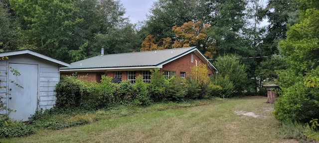 view of side of home featuring a lawn