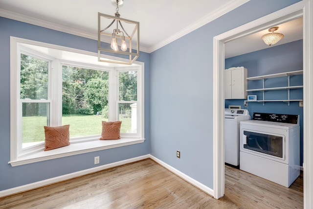 3103 Holly Haven Dr, Augusta, GA 30907 - kitchen with healthy amount of natural light, wood finished floors, a chandelier, ornamental molding, and separate washer and dryer