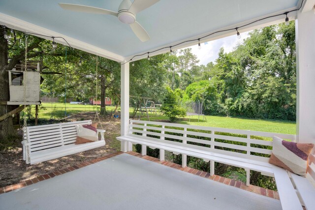 3103 Holly Haven Dr, Augusta, GA 30907 - view of patio with ceiling fan, a trampoline, view of scattered trees, and a playground