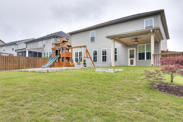 rear view of property with a playground, a ceiling fan, and a sunroom