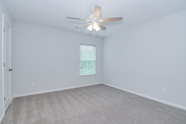 unfurnished room with ceiling fan, carpet floors, and baseboards
