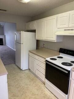 kitchen with white cabinets, white appliances, and exhaust hood