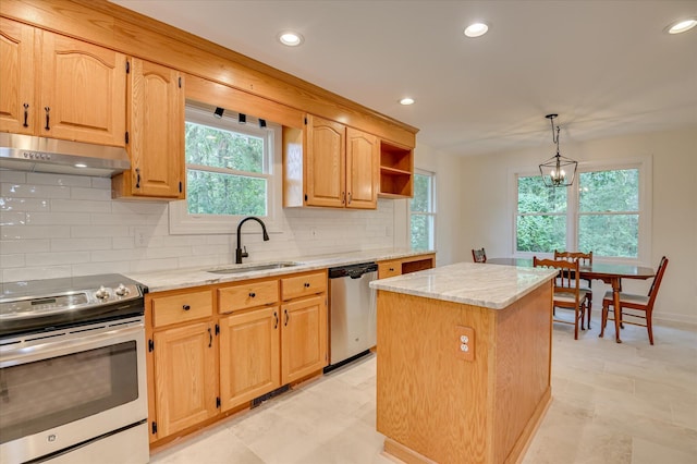 301 Misty Cv, Mccormick, SC 29835 - kitchen with appliances with stainless steel finishes, under cabinet range hood, a center island, tasteful backsplash, and light stone counters
