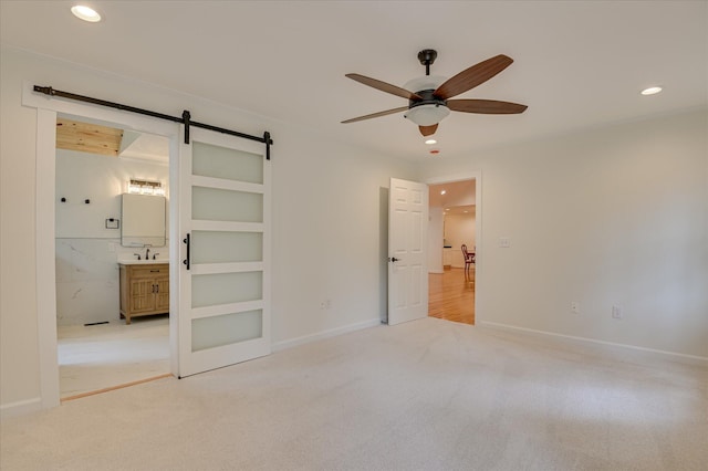 301 Misty Cv, Mccormick, SC 29835 - unfurnished bedroom with a barn door, carpet flooring, recessed lighting, ensuite bath, and ceiling fan