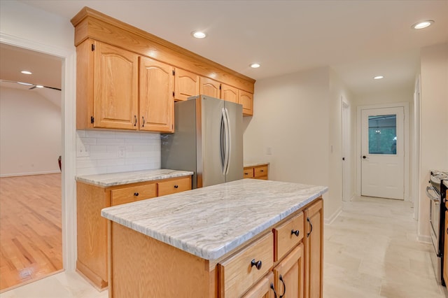 301 Misty Cv, Mccormick, SC 29835 - kitchen featuring freestanding refrigerator, recessed lighting, backsplash, light brown cabinets, and a center island