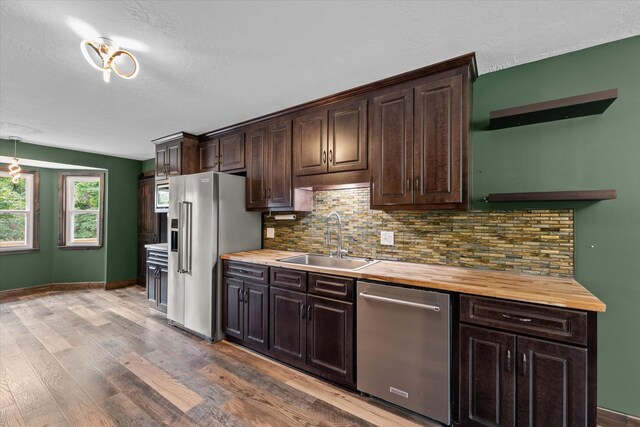221 Creek View Cir, Martinez, GA 30907 - kitchen with stainless steel appliances, butcher block counters, dark brown cabinetry, tasteful backsplash, and a textured ceiling