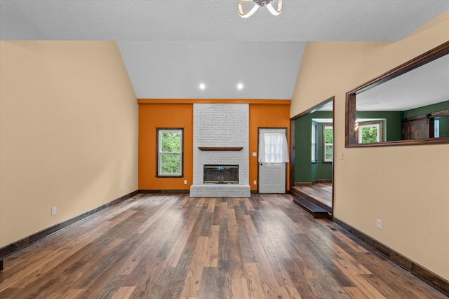 221 Creek View Cir, Martinez, GA 30907 - unfurnished living room featuring lofted ceiling, plenty of natural light, a brick fireplace, wood finished floors, and recessed lighting