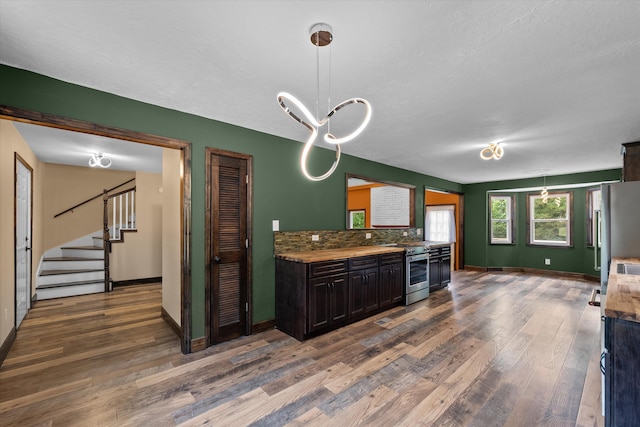 221 Creek View Cir, Martinez, GA 30907 - kitchen featuring wood finished floors, backsplash, stainless steel appliances, and hanging light fixtures