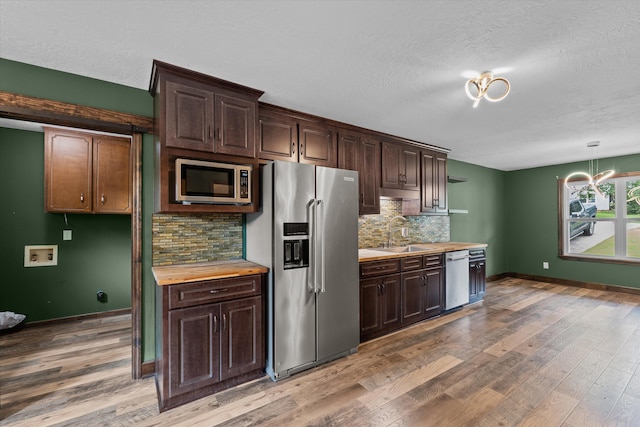 221 Creek View Cir, Martinez, GA 30907 - kitchen featuring appliances with stainless steel finishes, backsplash, dark brown cabinets, and a textured ceiling