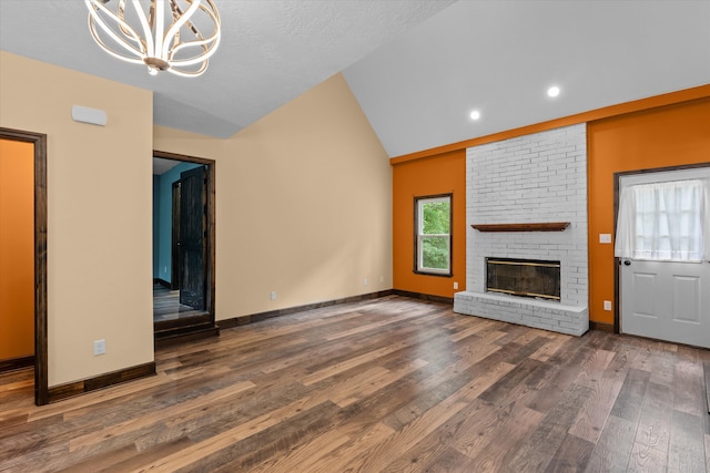 221 Creek View Cir, Martinez, GA 30907 - unfurnished living room featuring a fireplace, vaulted ceiling, wood finished floors, a chandelier, and recessed lighting