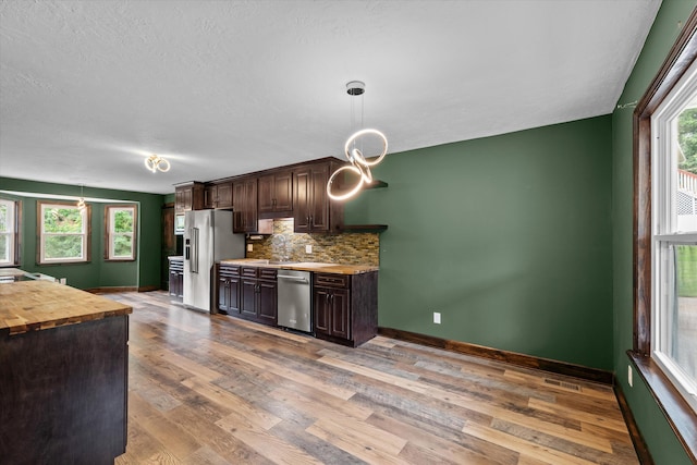 221 Creek View Cir, Martinez, GA 30907 - kitchen with stainless steel appliances, wood counters, dark brown cabinetry, wood finished floors, and pendant lighting