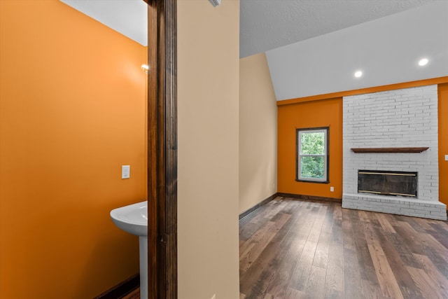 221 Creek View Cir, Martinez, GA 30907 - unfurnished living room with lofted ceiling, wood finished floors, a brick fireplace, and recessed lighting