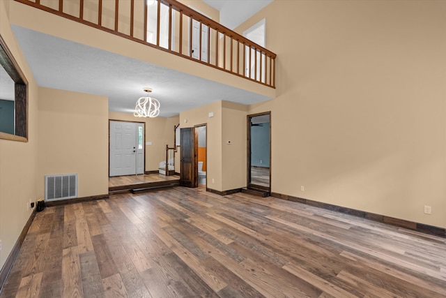 221 Creek View Cir, Martinez, GA 30907 - unfurnished living room with hardwood / wood-style flooring, a chandelier, and a high ceiling
