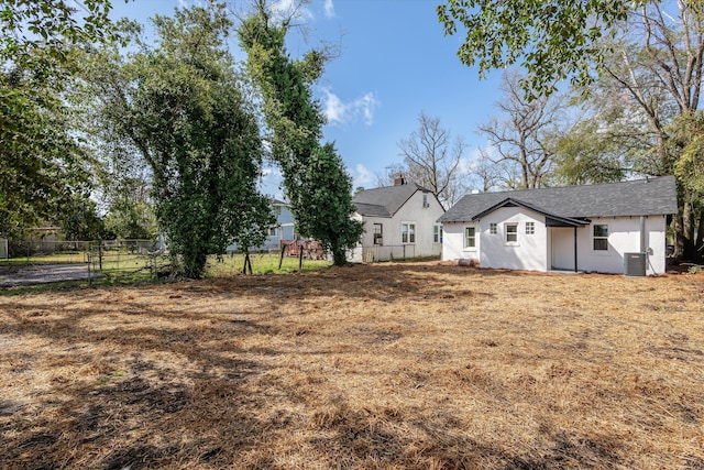 view of yard featuring fence and cooling unit