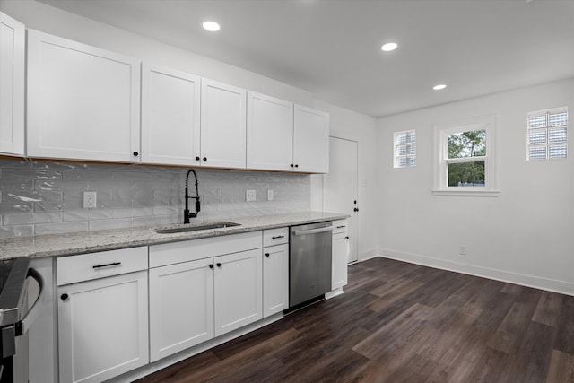 kitchen featuring dark wood-style floors, backsplash, stainless steel dishwasher, white cabinetry, and a sink