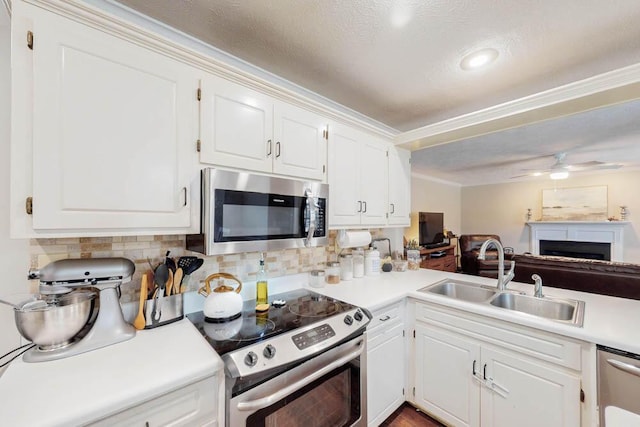 203 Longstreet Xing, North Augusta, SC 29860 - kitchen featuring appliances with stainless steel finishes, light countertops, white cabinetry, ornamental molding, and a ceiling fan