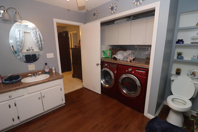 laundry area with sink, ceiling fan, separate washer and dryer, and dark hardwood / wood-style floors