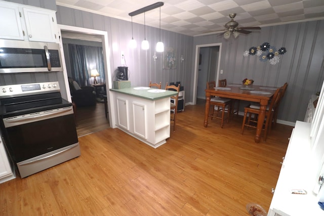 kitchen featuring stainless steel appliances, white cabinetry, ceiling fan, light hardwood / wood-style floors, and pendant lighting