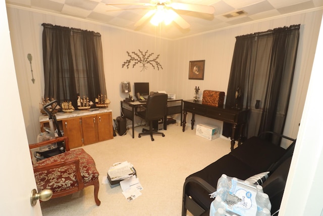 home office with carpet flooring, ceiling fan, and ornamental molding