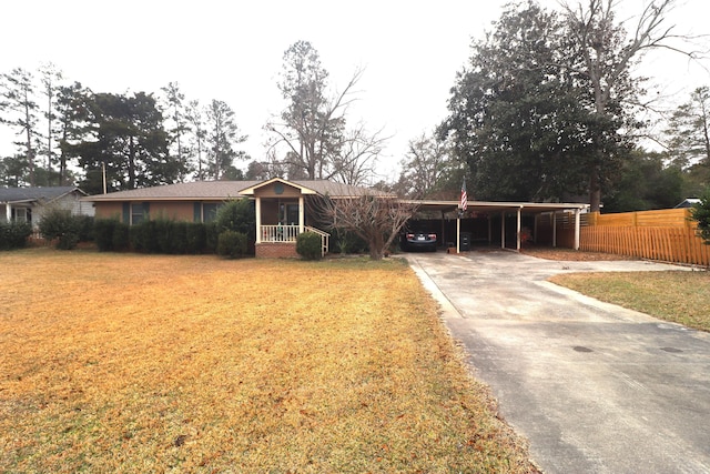 ranch-style house featuring a front yard and a carport