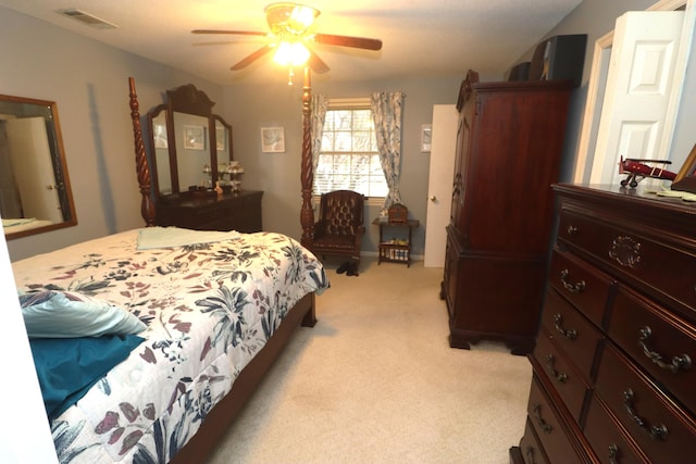 bedroom with ceiling fan and light carpet