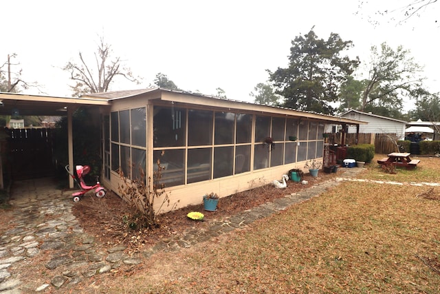 view of side of property with a sunroom