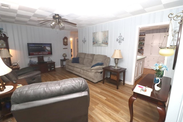 living room featuring light hardwood / wood-style floors and ceiling fan