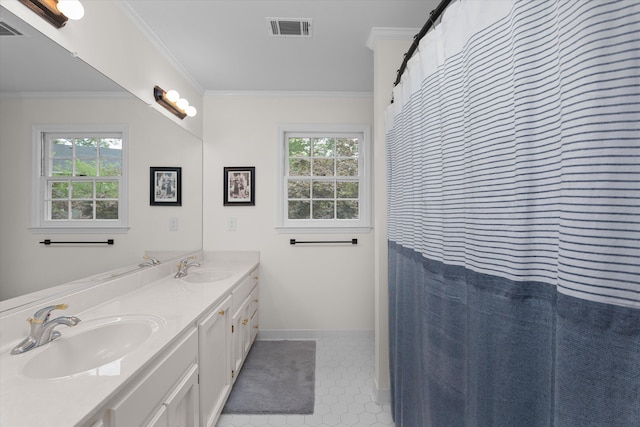 bathroom featuring ornamental molding, visible vents, a healthy amount of sunlight, and a sink