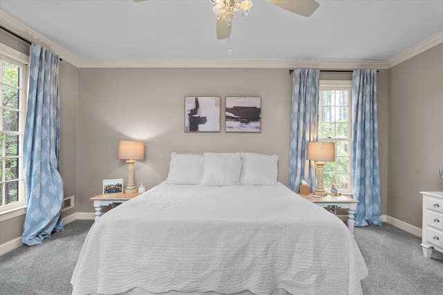 bedroom featuring crown molding, baseboards, a ceiling fan, and carpet flooring