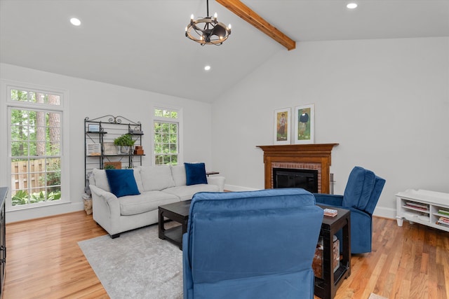living room with a brick fireplace, wood finished floors, recessed lighting, vaulted ceiling with beams, and a chandelier