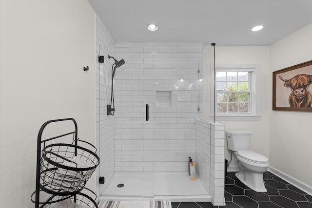 bathroom featuring recessed lighting, baseboards, a stall shower, and toilet