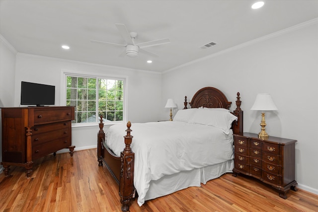 bedroom featuring visible vents, recessed lighting, crown molding, and wood finished floors