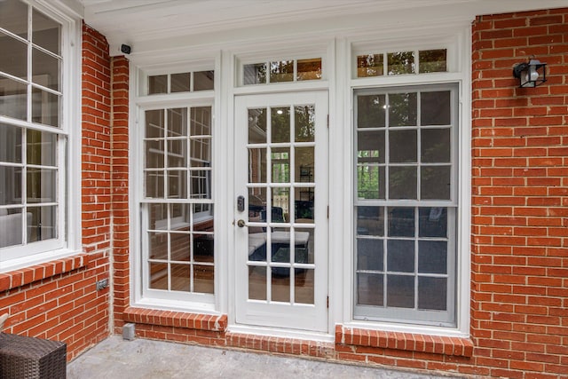 entrance to property featuring brick siding