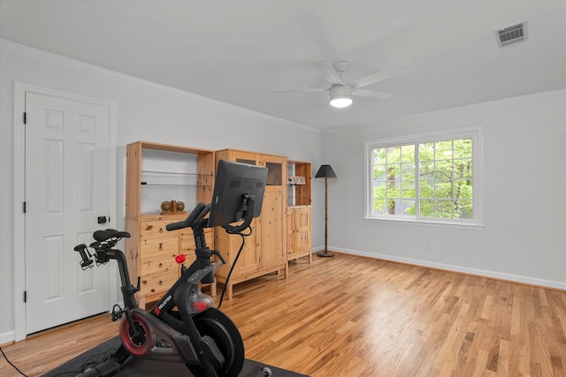 workout area featuring baseboards, ceiling fan, light wood-type flooring, and visible vents