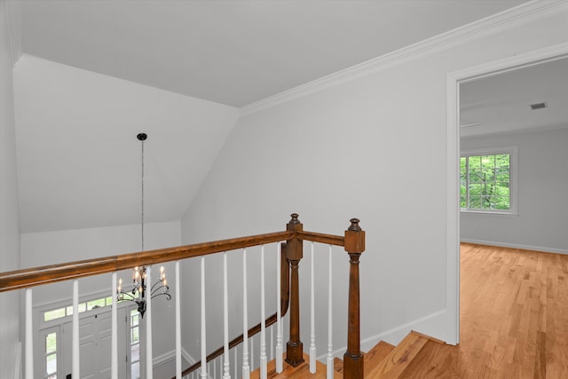hallway featuring baseboards, an upstairs landing, an inviting chandelier, and light wood finished floors