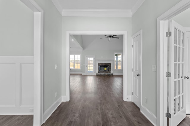 hall featuring lofted ceiling, dark hardwood / wood-style flooring, and crown molding