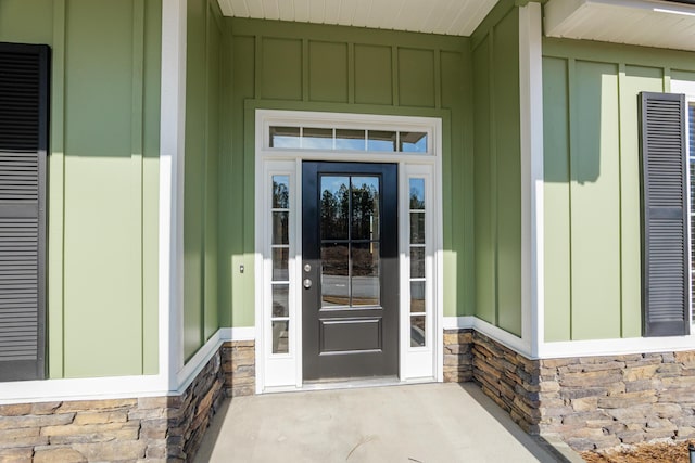 property entrance featuring stone siding