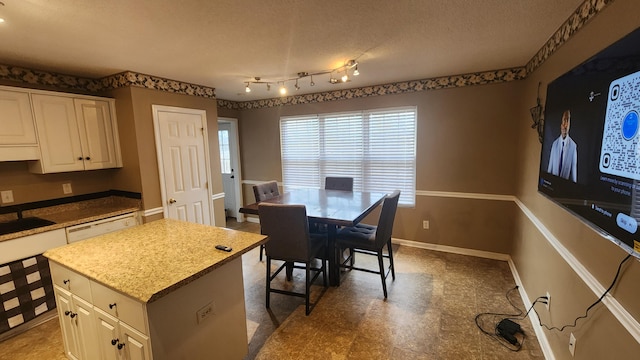 dining space featuring a textured ceiling and sink