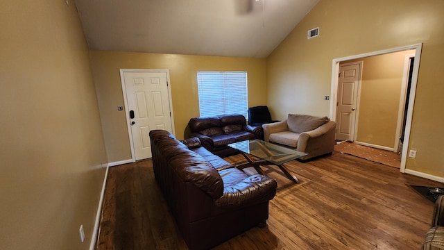 living room with dark hardwood / wood-style flooring and lofted ceiling