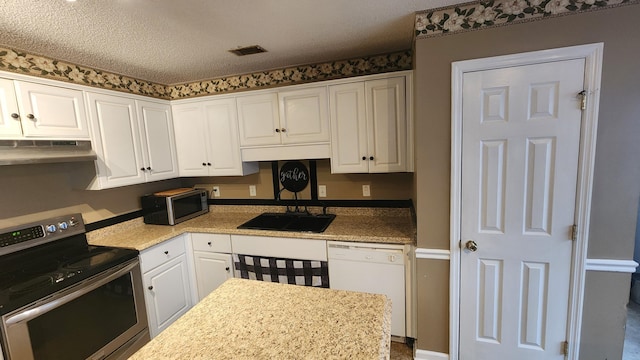 kitchen featuring white cabinets, sink, appliances with stainless steel finishes, and a textured ceiling