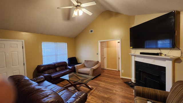 living room with ceiling fan, lofted ceiling, and hardwood / wood-style flooring