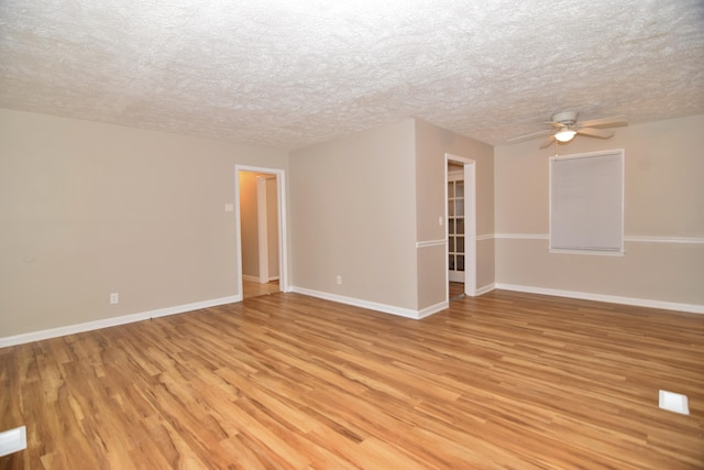 unfurnished room featuring ceiling fan, light hardwood / wood-style floors, and a textured ceiling