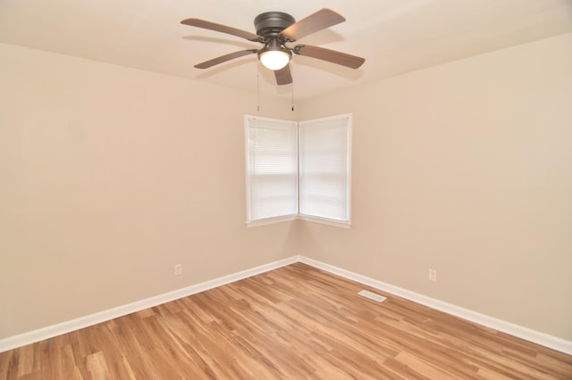 spare room featuring light hardwood / wood-style floors and ceiling fan