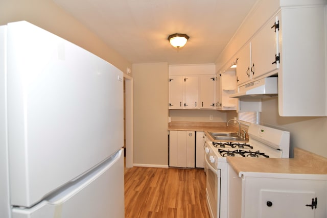 kitchen with white cabinets, white appliances, light hardwood / wood-style floors, and sink