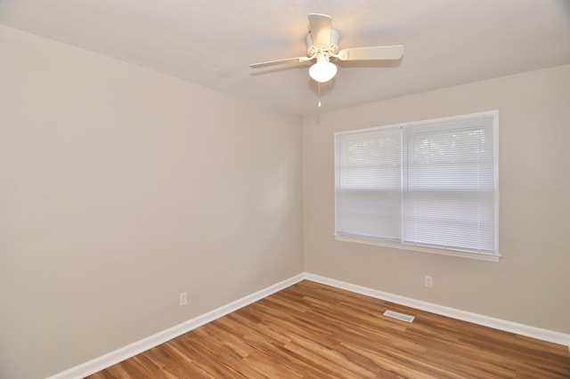 unfurnished room with hardwood / wood-style flooring and ceiling fan