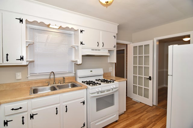 kitchen with white appliances, light hardwood / wood-style floors, white cabinetry, and sink