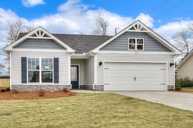 craftsman inspired home featuring a front yard, an attached garage, stone siding, and concrete driveway