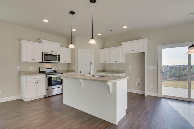 kitchen featuring white cabinets, an island with sink, appliances with stainless steel finishes, light countertops, and a sink